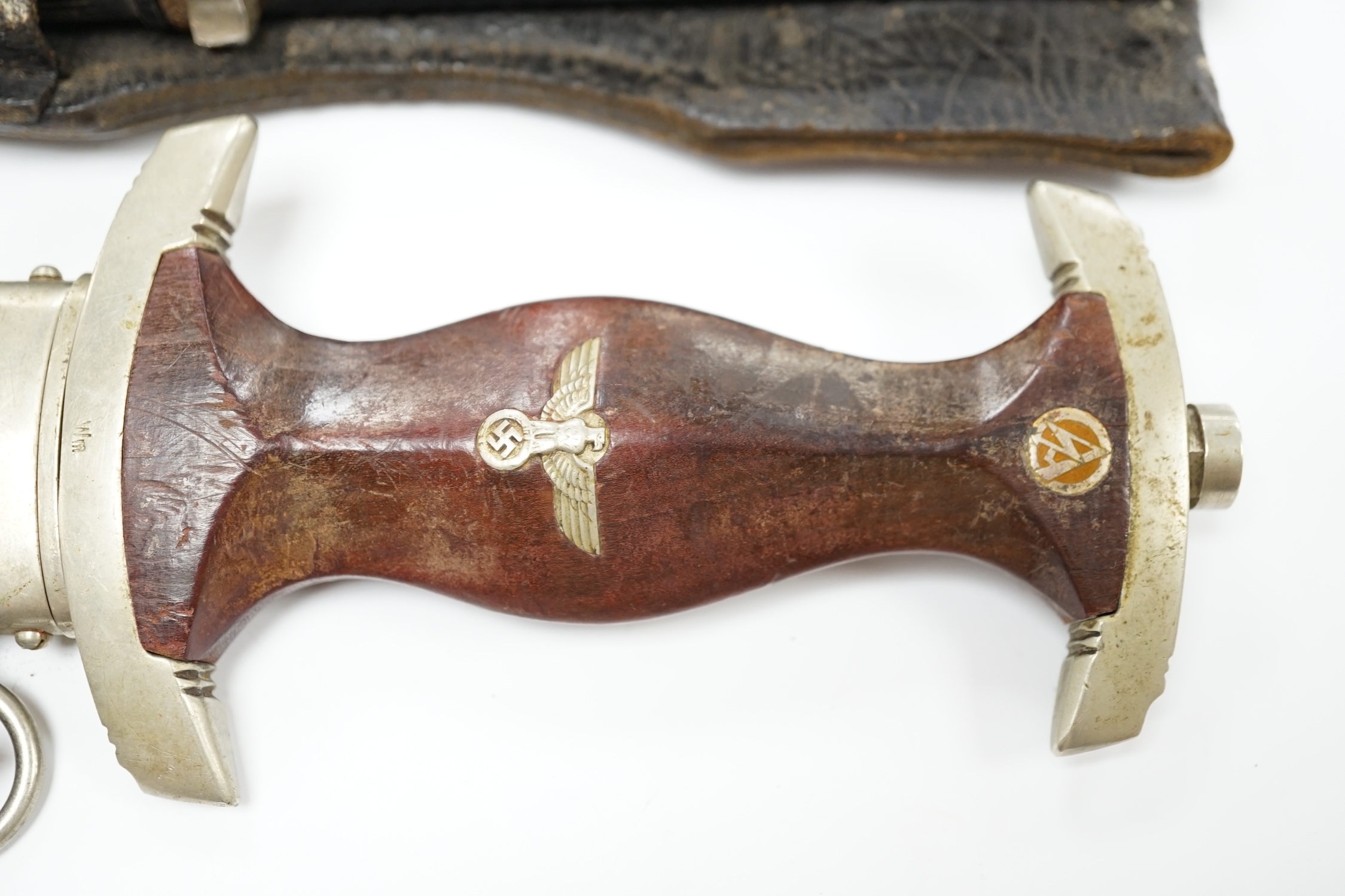 A WWII German SA dagger, regulation pattern in its steel scabbard with regulation nickel mounts, and leather hanging band and a German dress bayonet by Paul Seilheimer. Condition - fair, some wear
